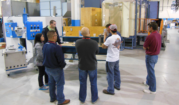 people gather round to learn more about powder coating equipment from Parker Ionics